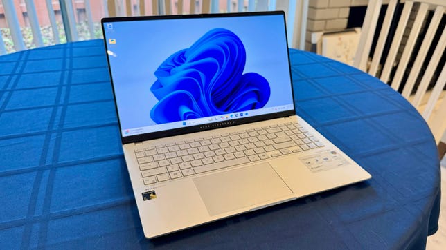 Asus Vivobook S15 on a table with a blue tablecloth