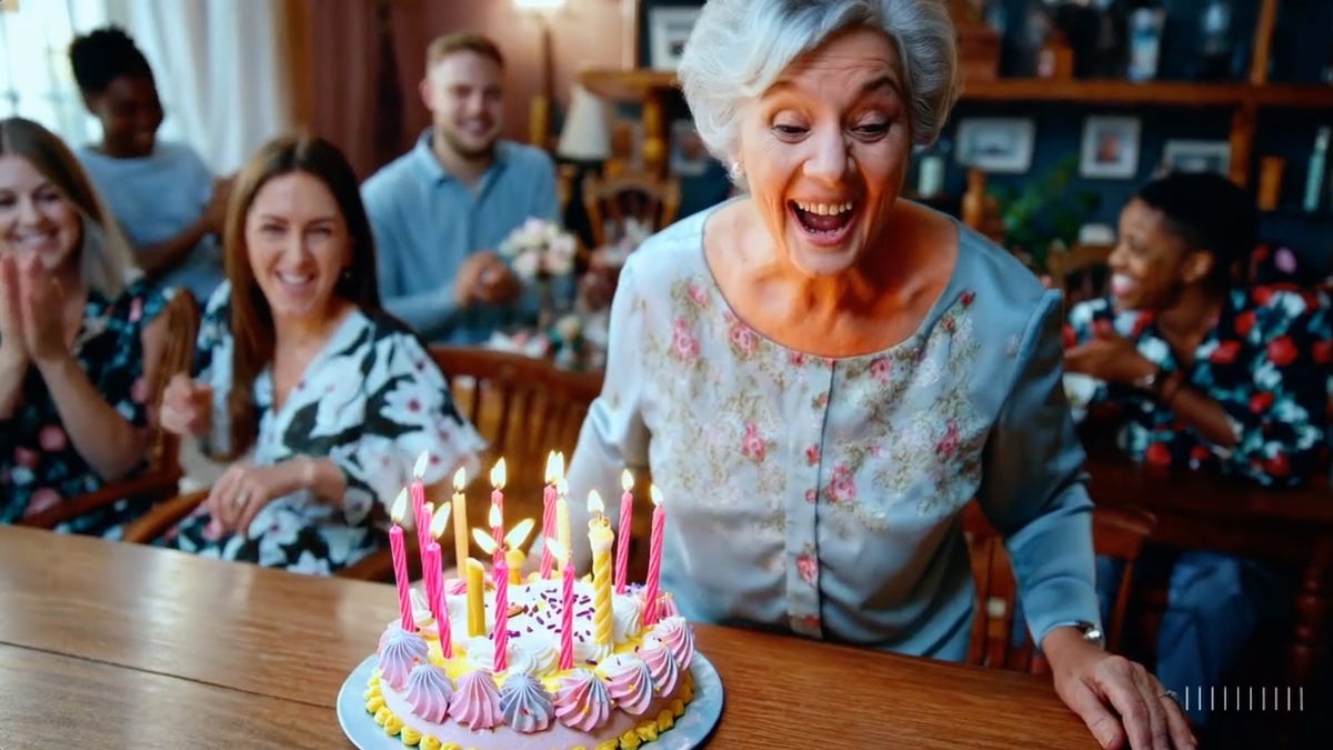 A woman prepares to blow out the candles on a birthday cake in a video generated by OpenAI's Sora.
