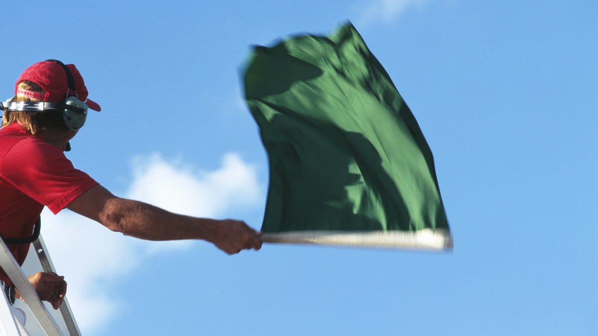 man waving green flag
