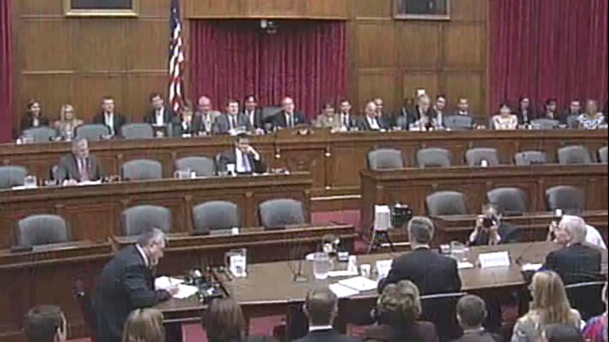 FCC commissioner Robert McDowell, seated in the middle of the witness table, warns that Google, iTunes, Facebook and Netflix could face new international taxes.