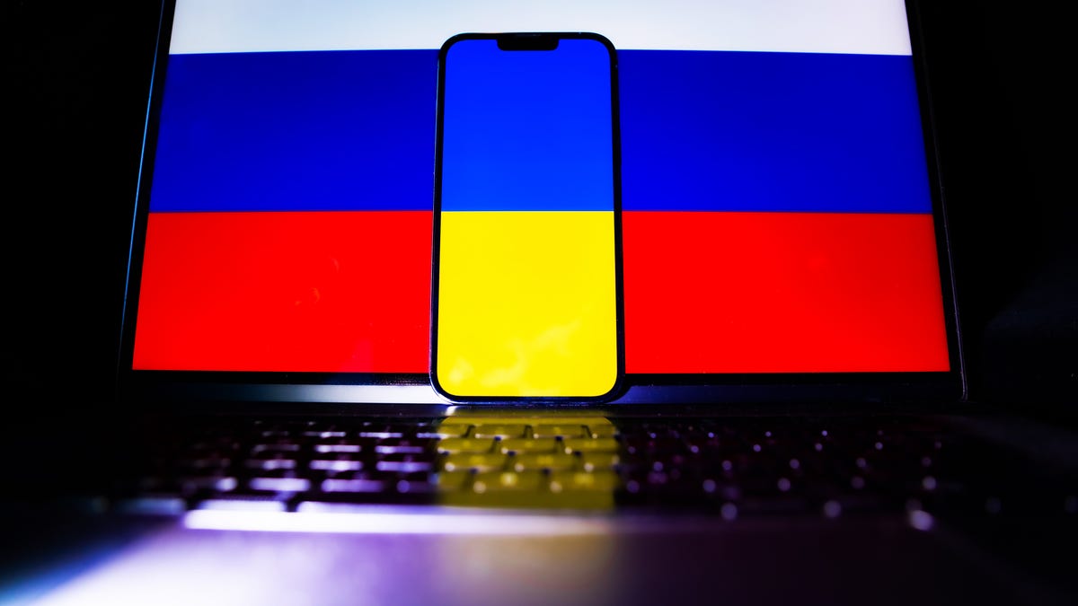 Russian and Ukrainian flags on phones and laptops