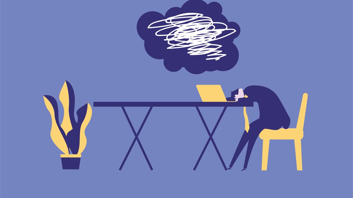 Illustration showing a stressed-out person with head down on a desk