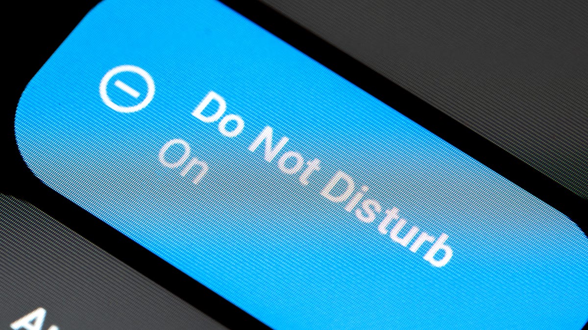 A close-up of a blue "do not disturb" icon on a phone screen that says it is on.