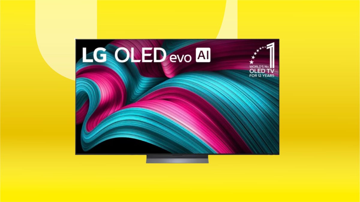 Black LG tv against a yellow background.