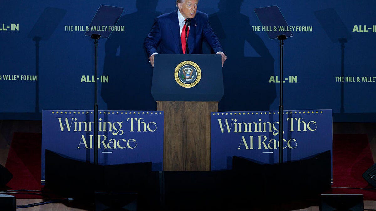 Trump at a podium in front of Winning the AI Race backdrops