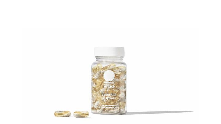 Bottle of Ritual womens 50+ multivitamin with two capsules in front