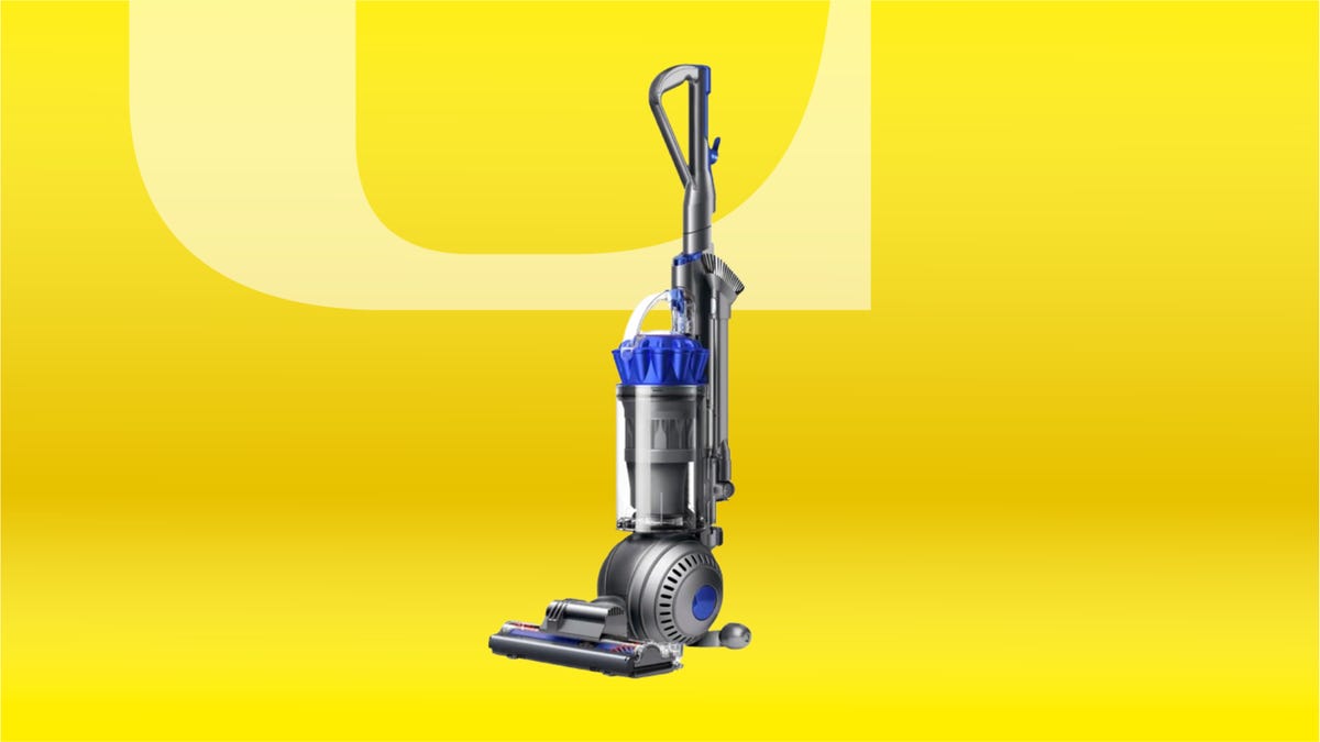 Steel and blue vacuum with ball base against yellow CNET background.