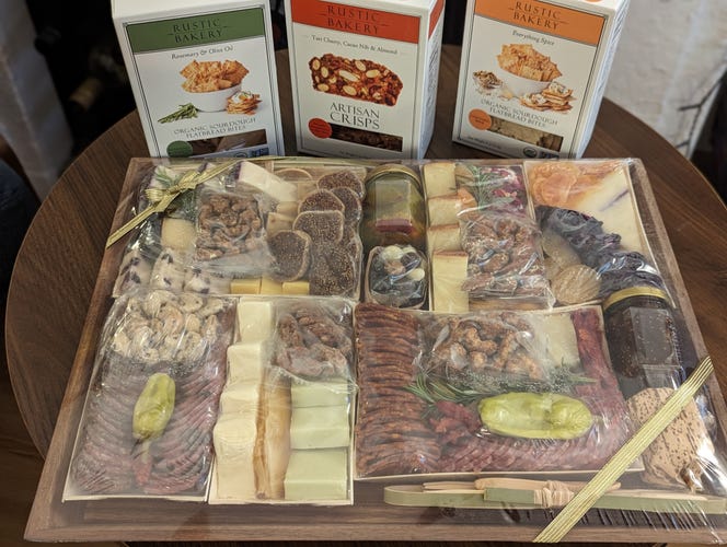 Cheese and charcuterie board with boxes of crackers