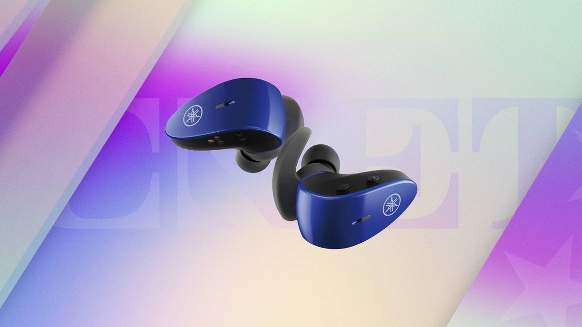 A pair of blue earbuds against a purple and tan CNET background.