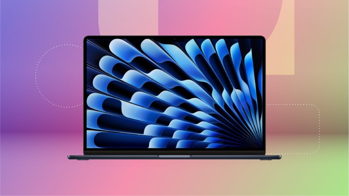 Black MacBok Pro laptop with blue wallpaper against purple, pink and green.