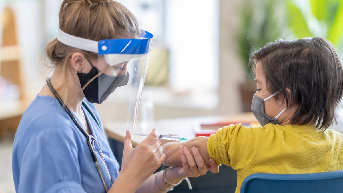 Nurse vaccinating a child