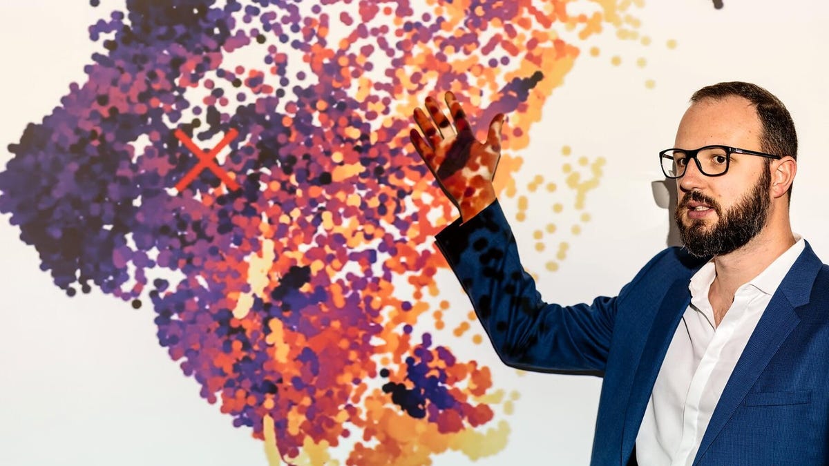 Microsoft researcher Nicolo Fusi shows research on the company's automated machine learning technology.