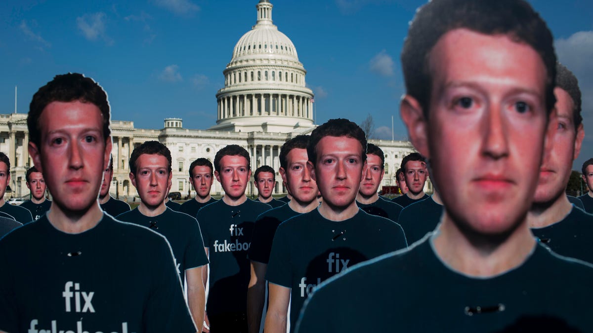 Cutouts of Facebook CEO Mark Zuckerberg in front of the US Capitol building.