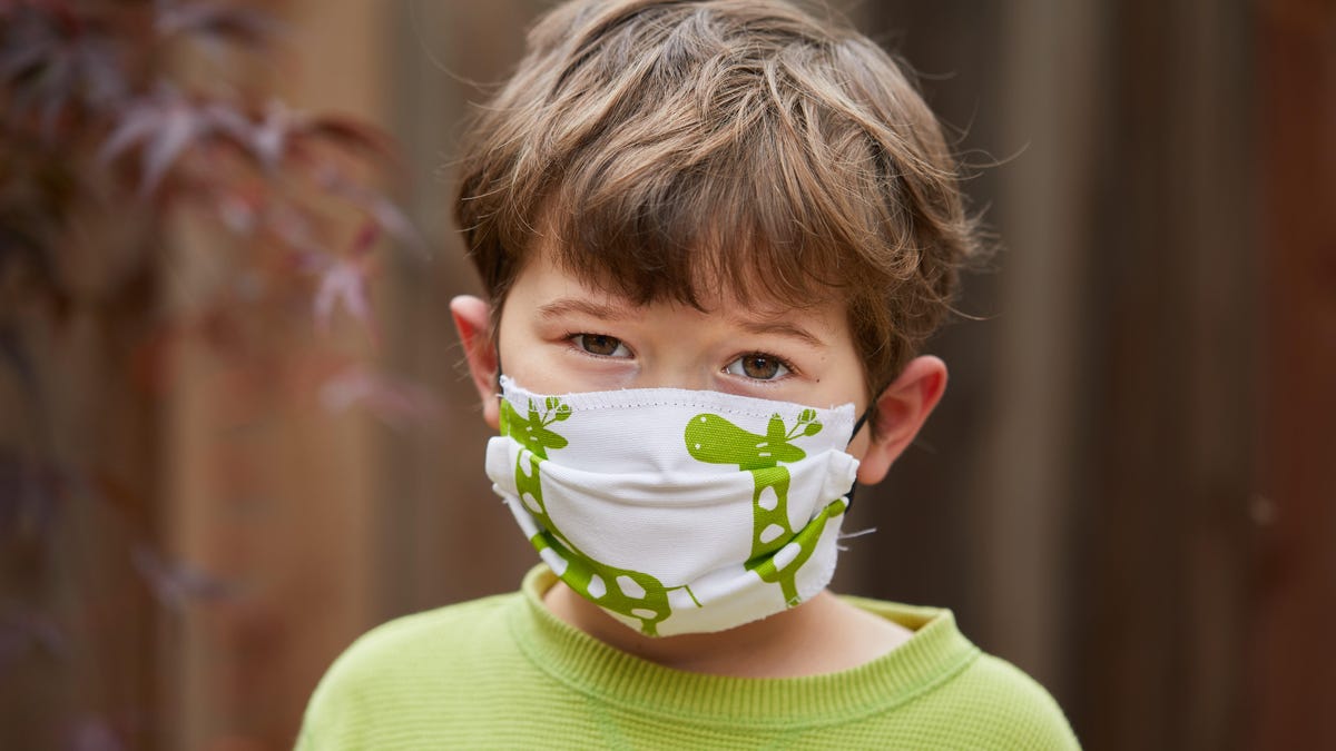 A boy wears a handmade mask to try to reduce transmission of COVID-19, the disease caused by the coronavirus.
