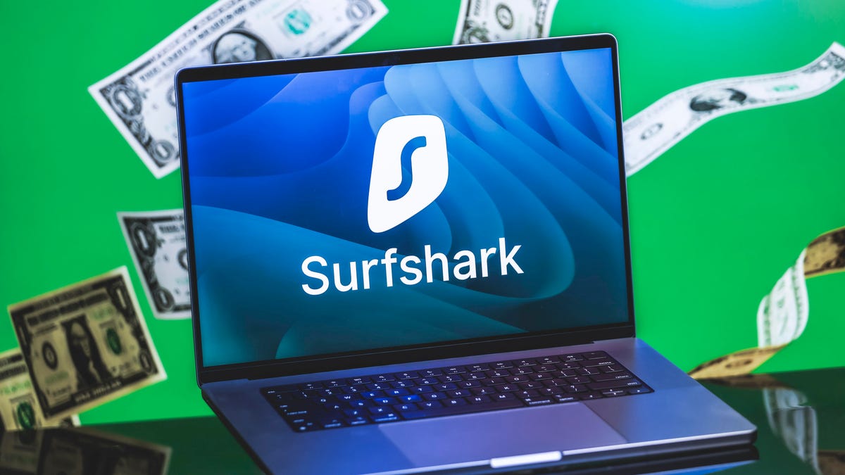 A laptop open with a SurfShark VPN logo on the screen.