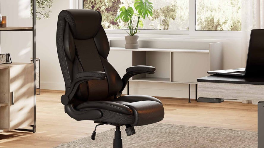 A black executive chair in a creamy office
