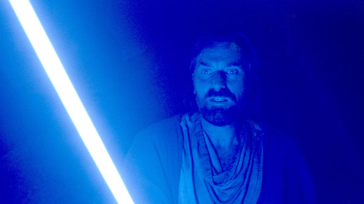 An angry alien bad guy lit by the glare of a red lightsaber in Obi-Wan Kenobi on Disney Plus.