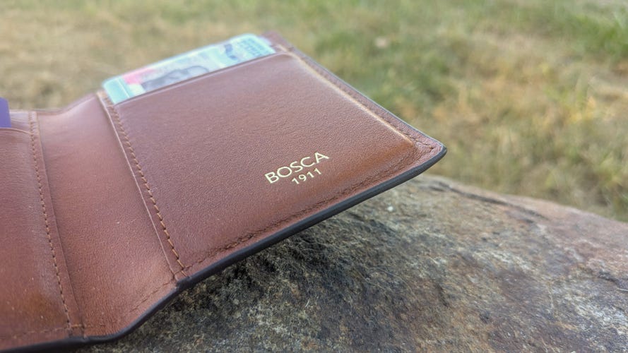 A brown leather wallet on a rock