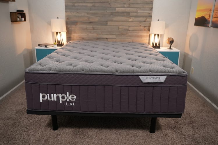 The Purple Rejuvenate Plus mattress in between two blue and white night stands.