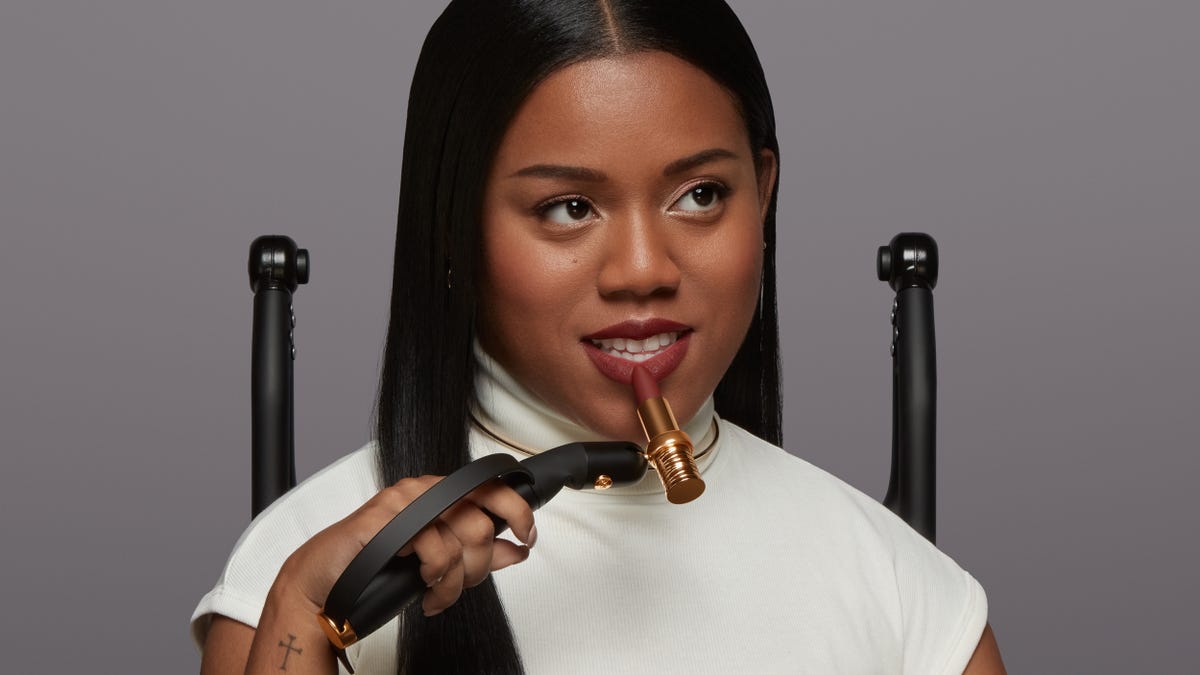 Young woman using the HAPTA makeup applicator to apply lipstick