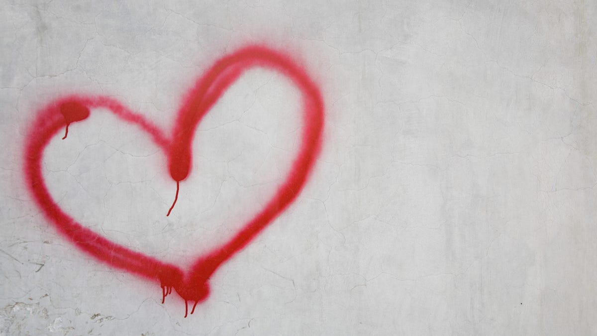 Red heart shape on white wall