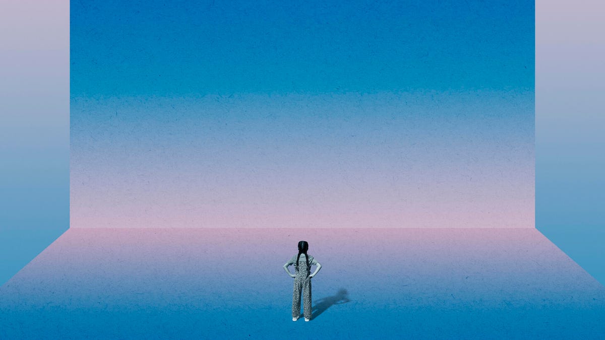 A woman standing in front of an enormous, blank blue screen (gettyimages-2150983459)