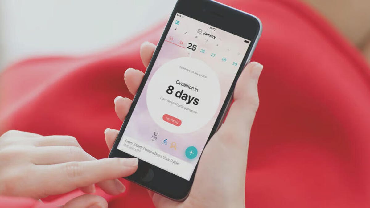 A phone showing marked days on the period tracking app Flo.