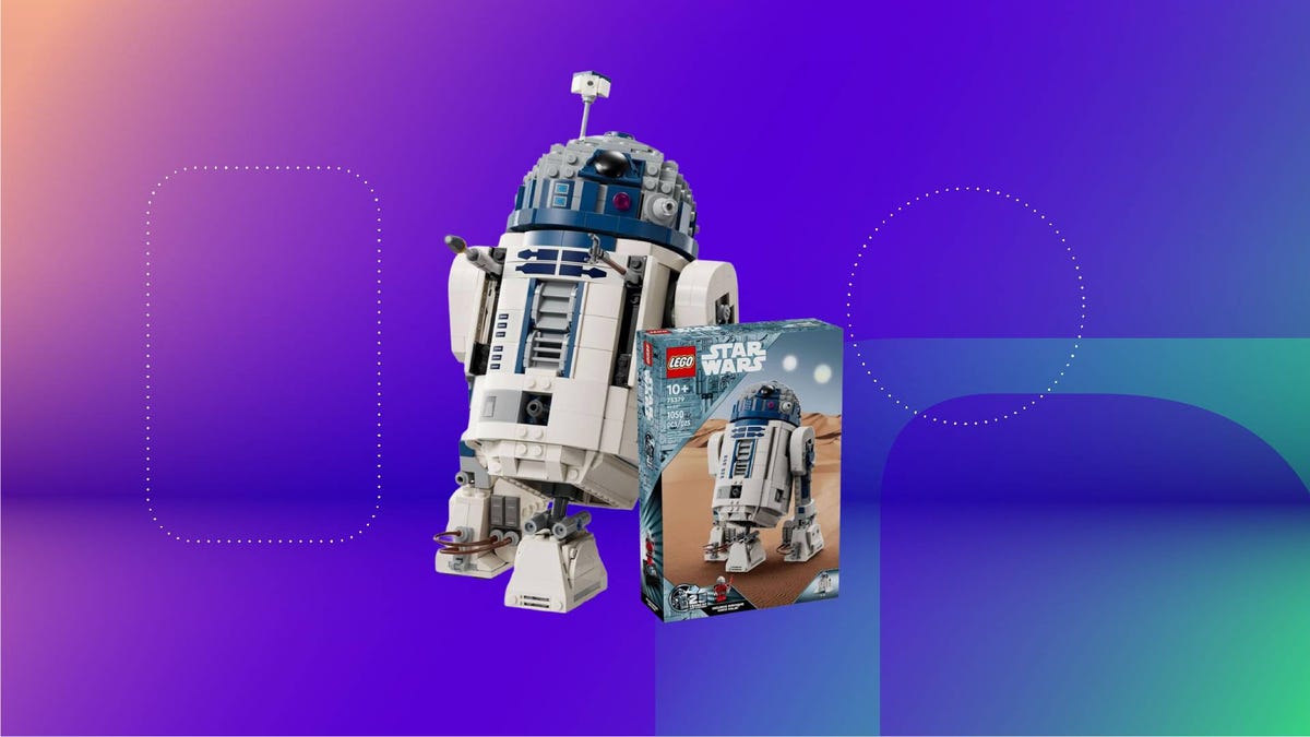 A built Lego R2-D2 set and box against a purple gradient CNET background.