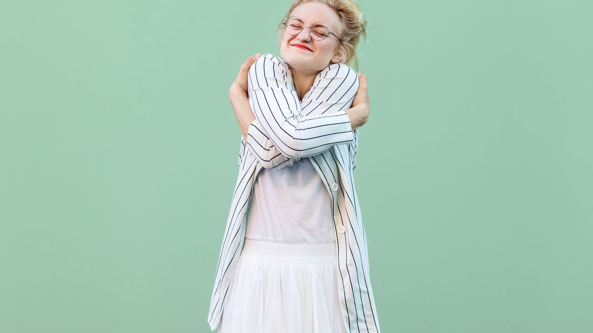 Woman giving herself en embrace.