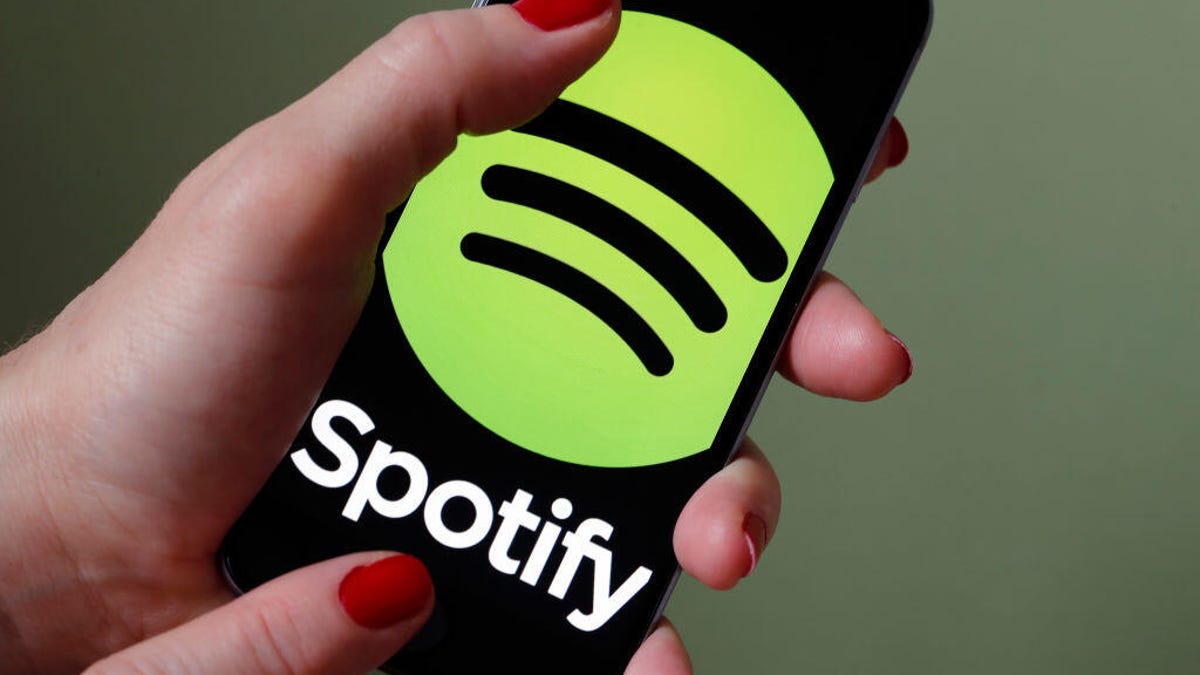 The Spotify logo is shown on a phone