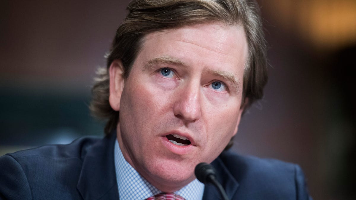 A closeup of Christopher Krebs in front of a small microphone at a congressional hearing.