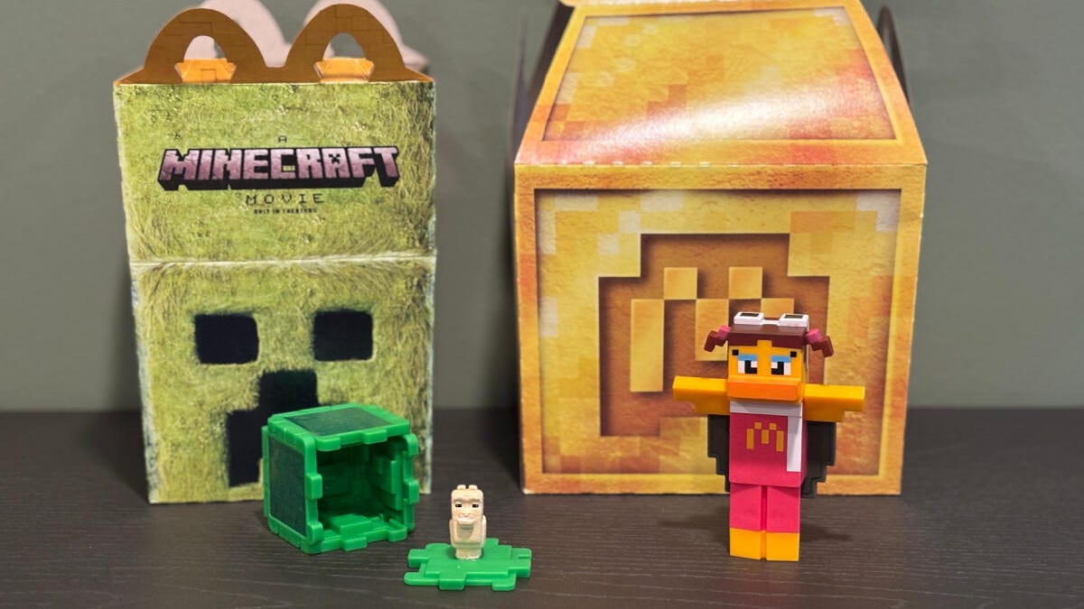 A Creeper Minecraft Happy Meal box and a gold block McDonald's box with toys.