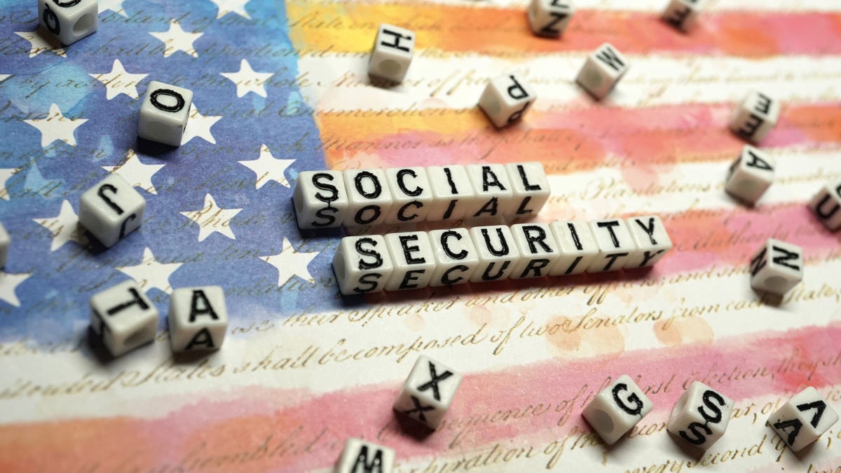 Social Security written on blocks on an American flag