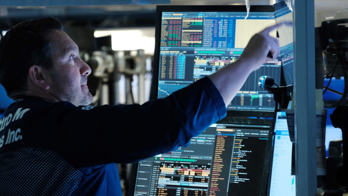 stock market trader looking at his monitor