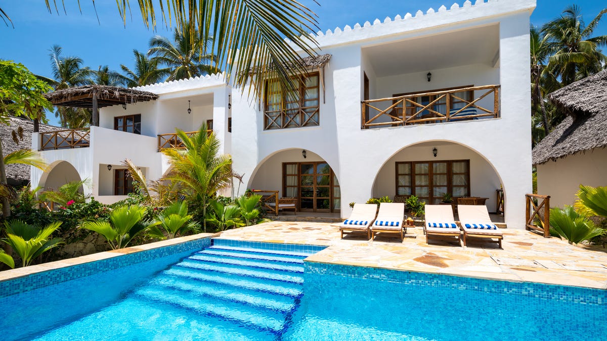 White Spanish style vacation home with pool
