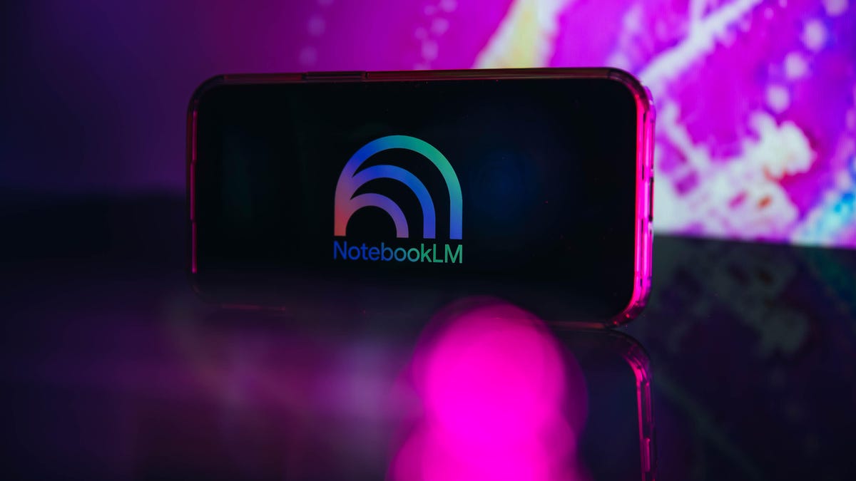 A cellphone in landscape mode has the NotebookLM logo on its screen.