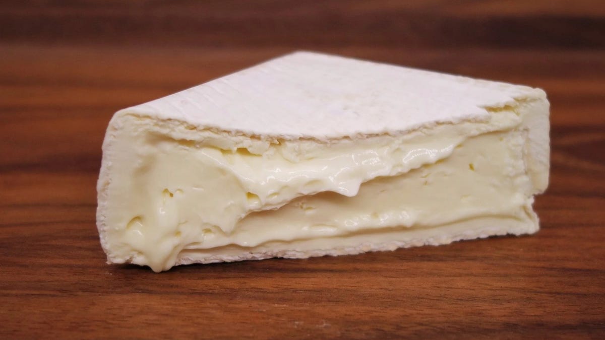 A slice of perfectly ripe brie cheese