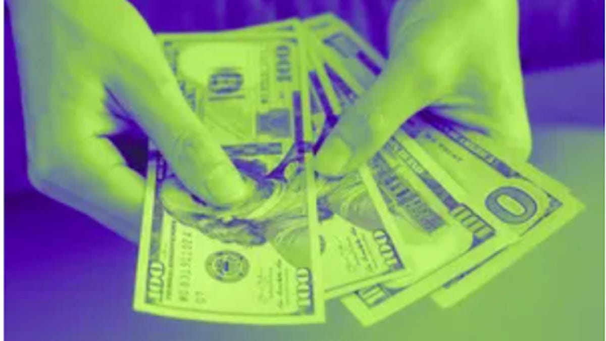 Hand with hundred dollar bills