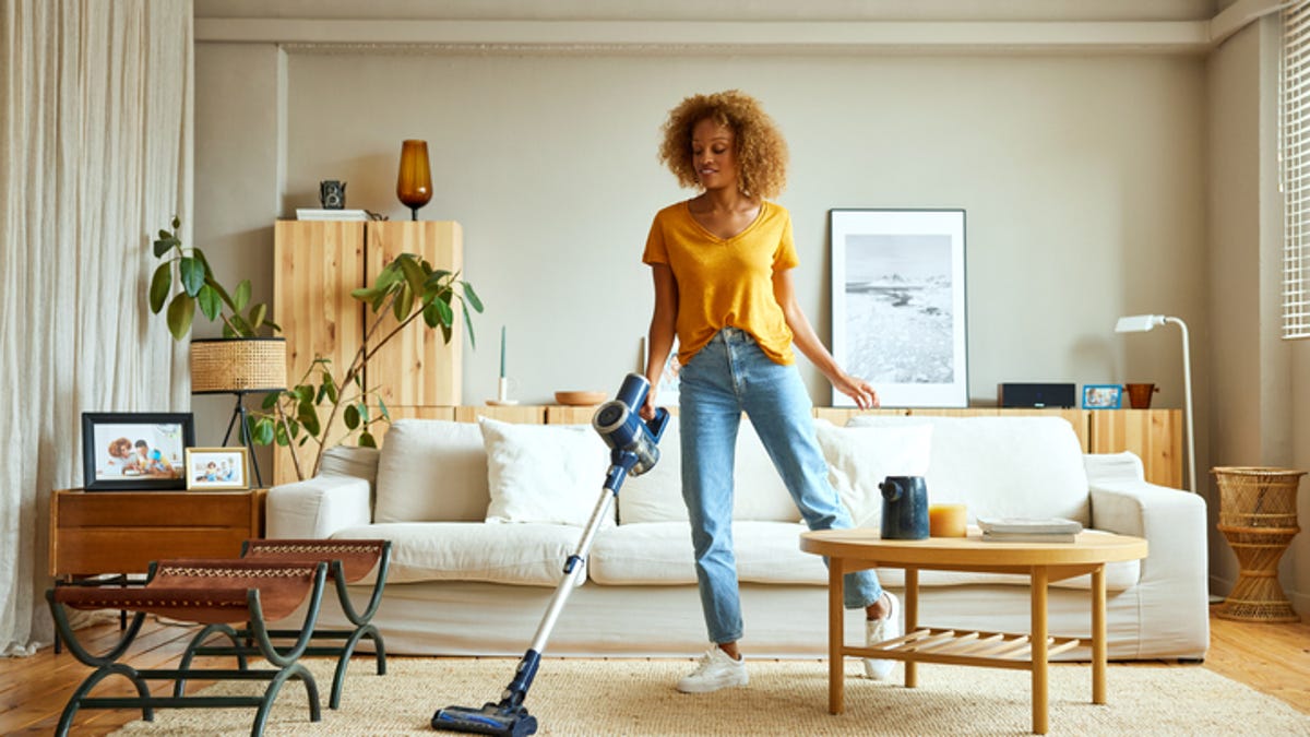 Woman vacuuming the run in her living room.