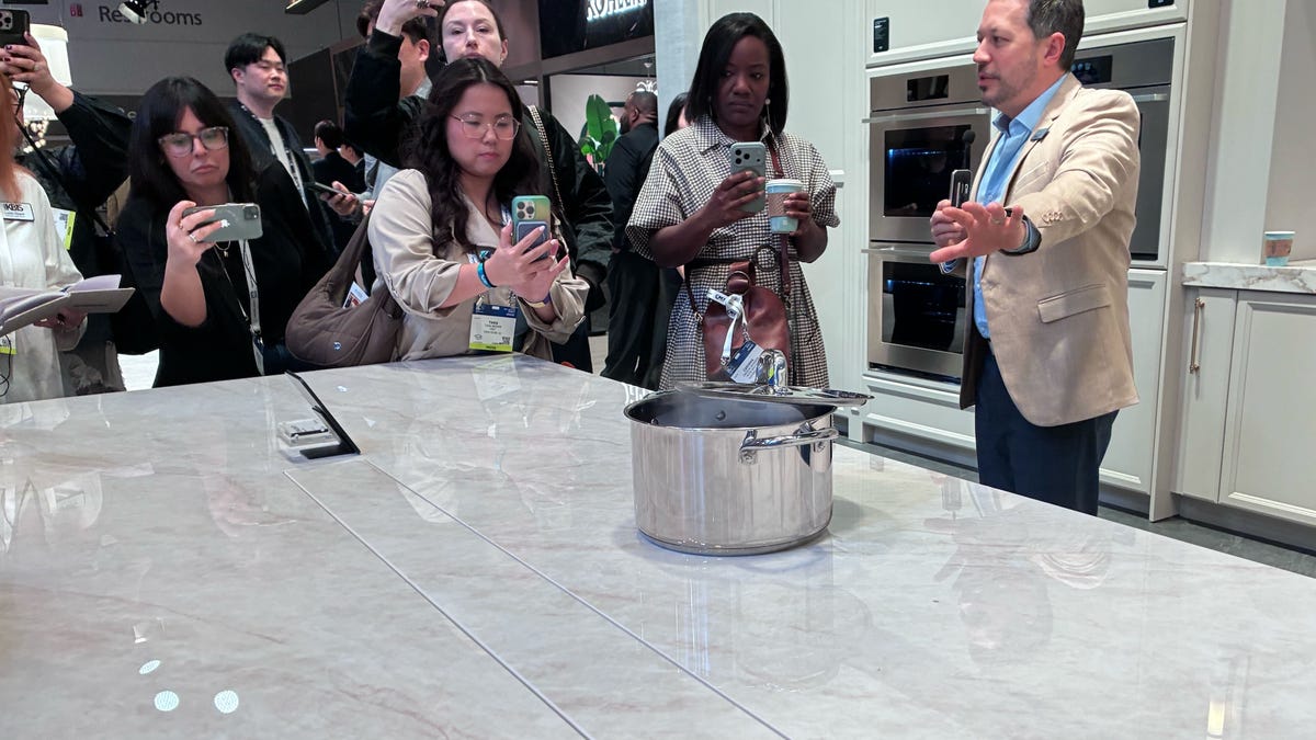 pot on countertop with crowd around taking photos