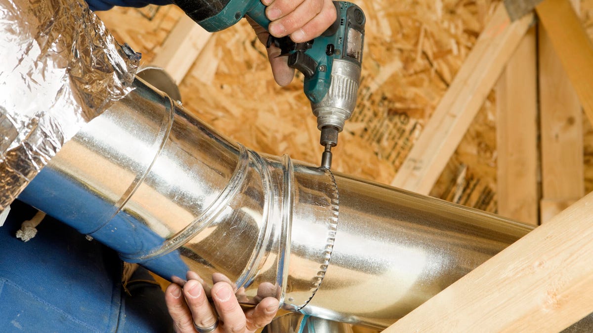 person drilling in ductwork