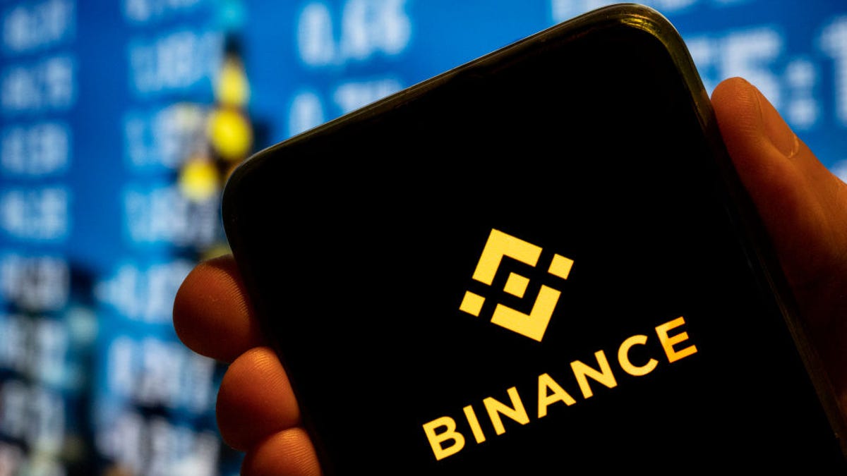 Binance logo with screens in the background