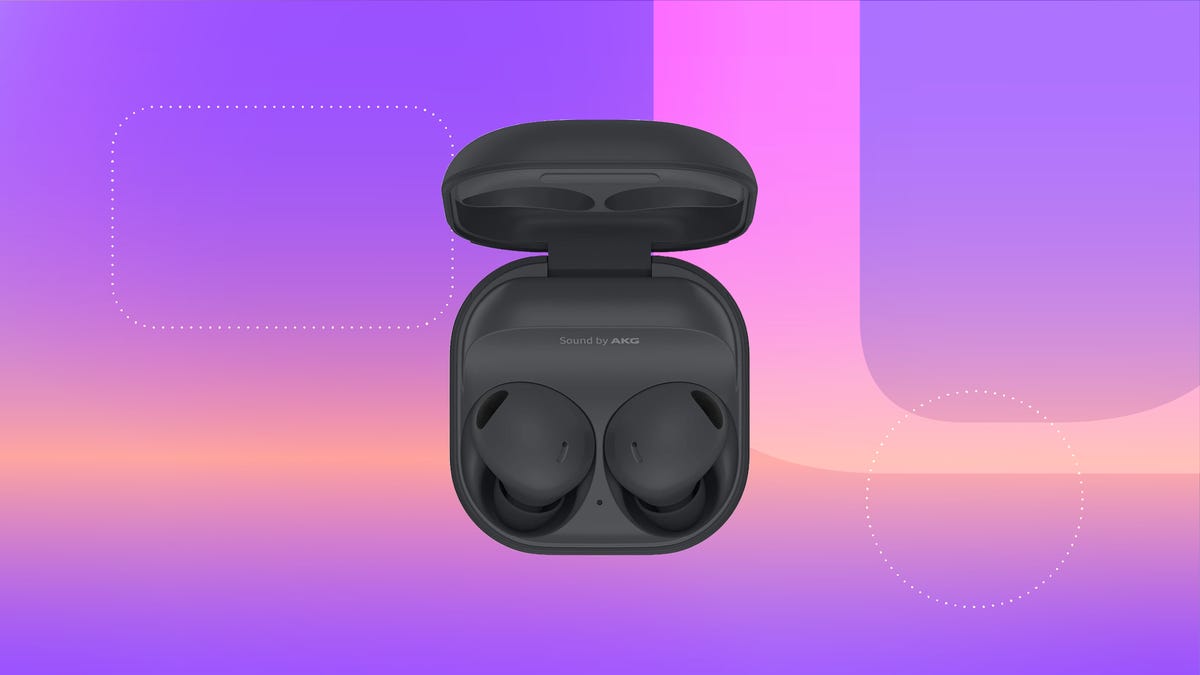 A pair of black Samsung earbuds in their charging case against a blue background.