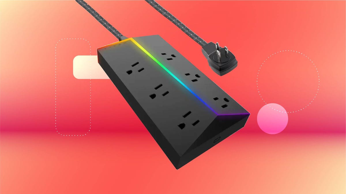 A black power strip with multicolor LED lighting against a red gradient CNET background.