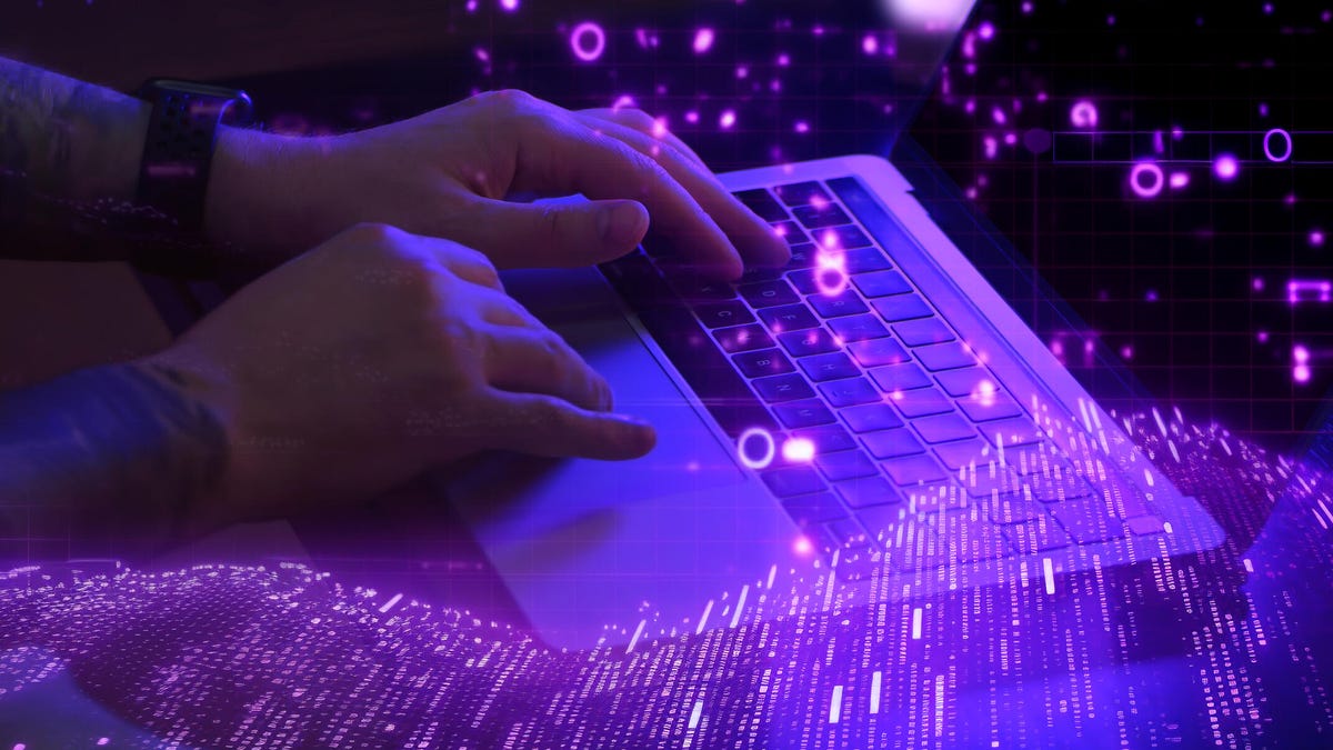 Image shows a keyboard glowing in neon colors.