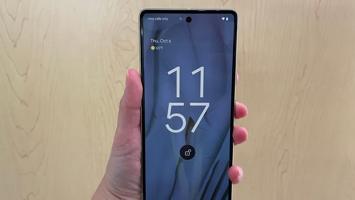 Google's Pixel 7 being shown from the front on a wooden backdrop.