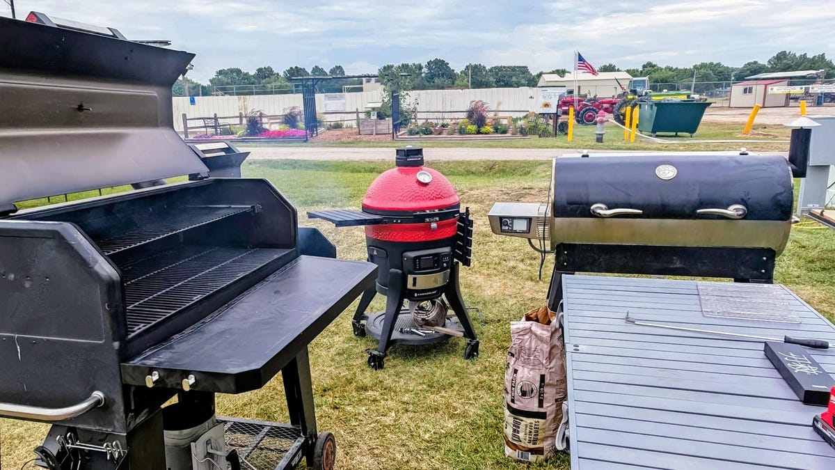 A Recteq Flagship XL 1400 pellet grill and smoker sitting outside on a concrete patio.