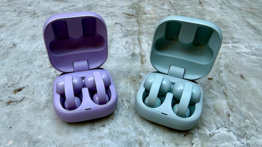 Shot of the Sony LinkBuds Clip in lavender and green with their cases open