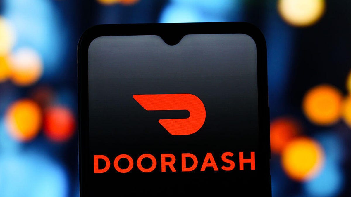 The DoorDash (Door Dash) logo is seen displayed on a smartphone screen