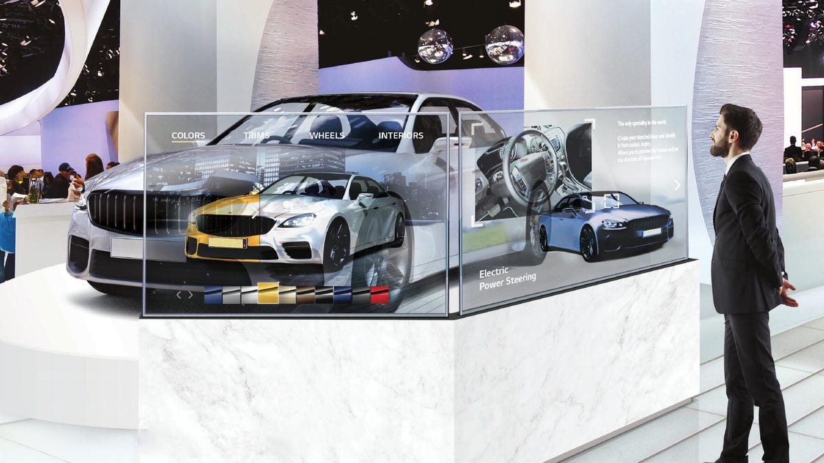 Two transparent OLEDs in front of a car.